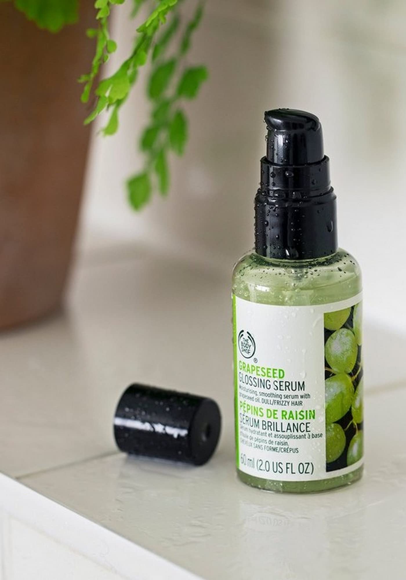 The Body Shop Grapeseed Glossing Serum bottle with dropper enables easy application for frizz-prone hair