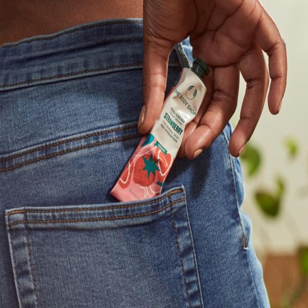 The Body Shop Strawberry Hand Cream application on skin for smooth, soft hands.