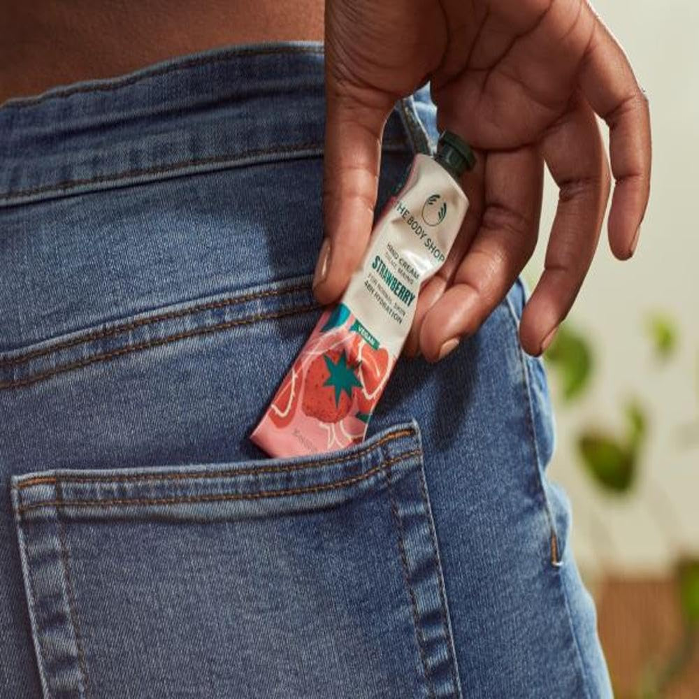 The Body Shop Strawberry Hand Cream application on skin for smooth, soft hands.