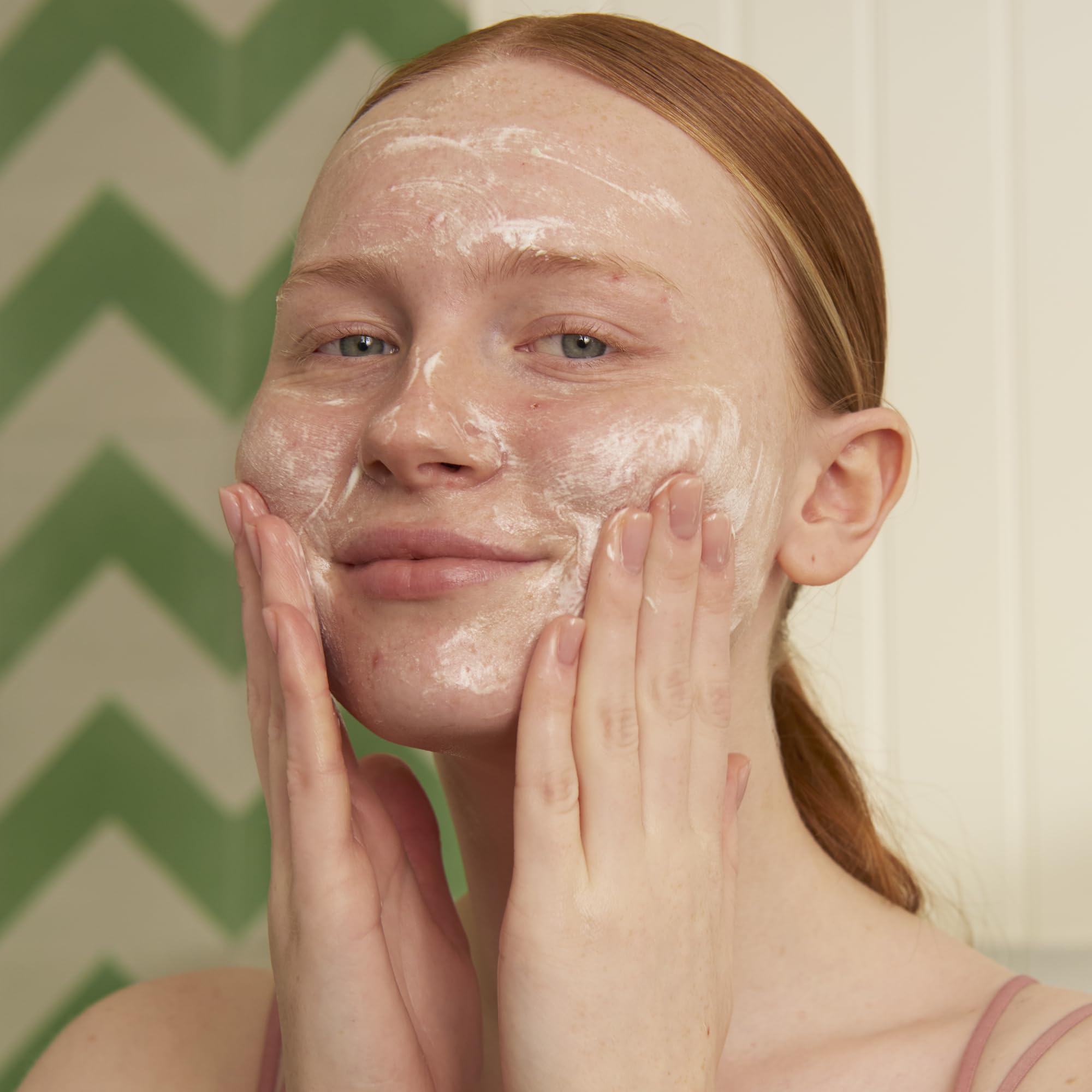 The Body Shop Tea Tree foaming cleanser closeup emphasizes instant lather that cleanses clogged pores.