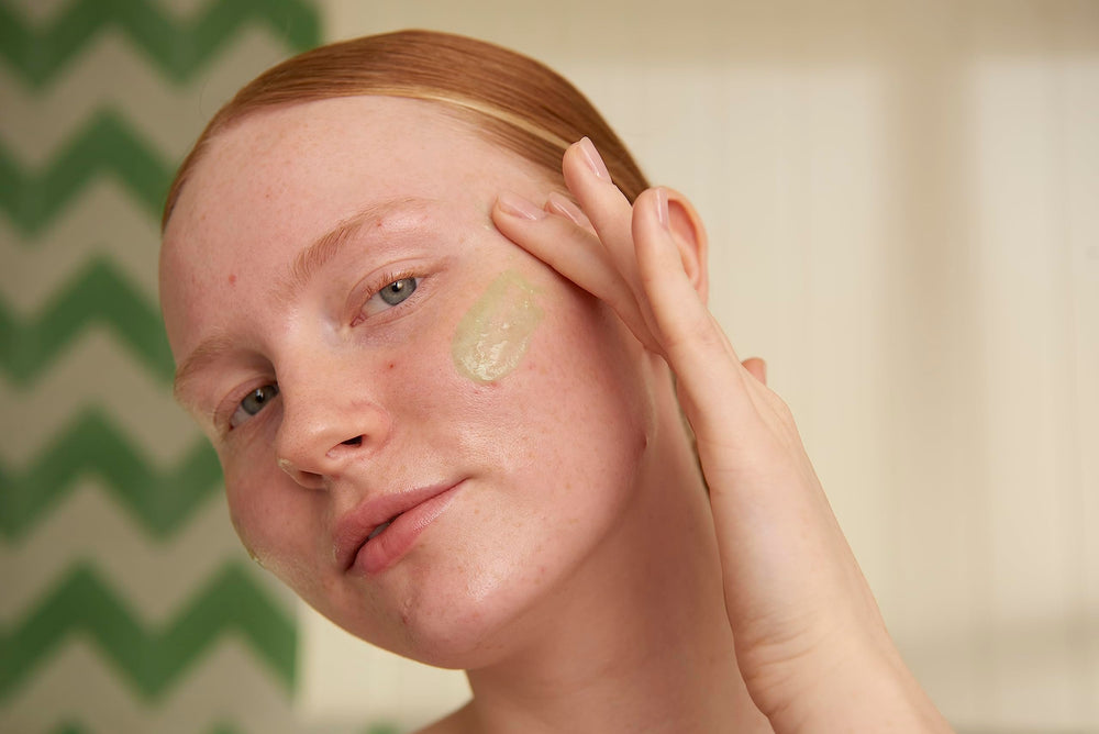 The Body Shop Tea Tree Scrub applying on the face demonstrates gentle cleansing and oil control