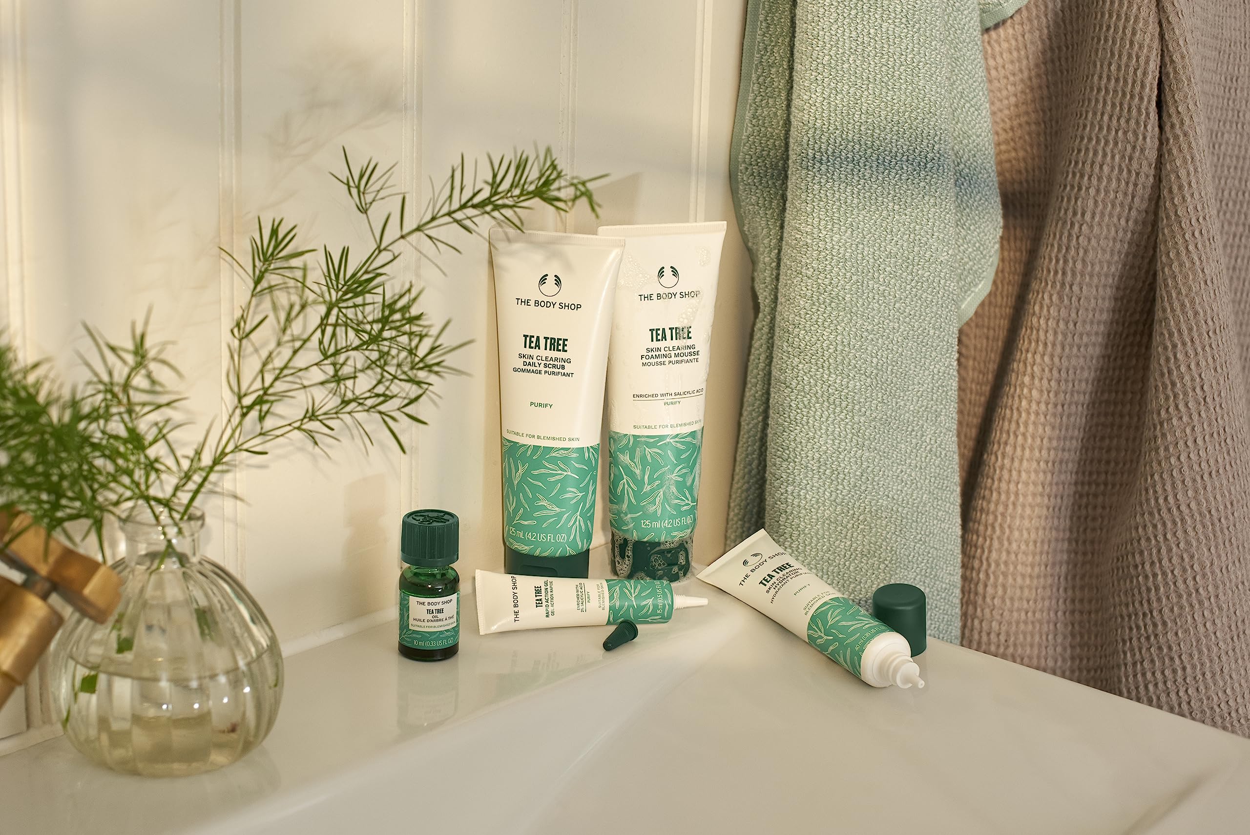 The Body Shop Tea Tree Scrub packaging highlights vegan certification and Community Fair Trade tea tree oil