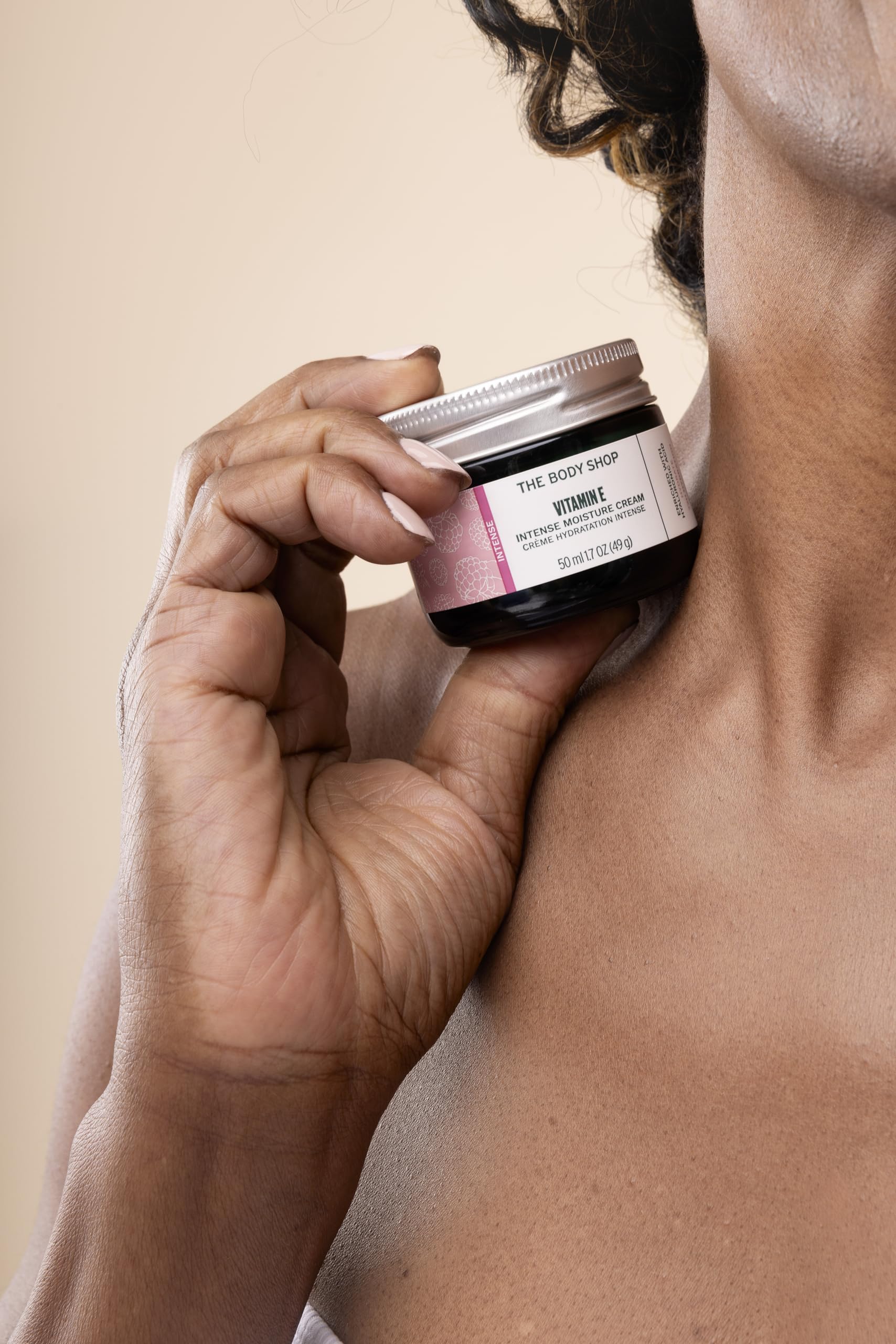 The Body Shop Vitamin E Intense Moisturizer label on jar highlights vegan formula.