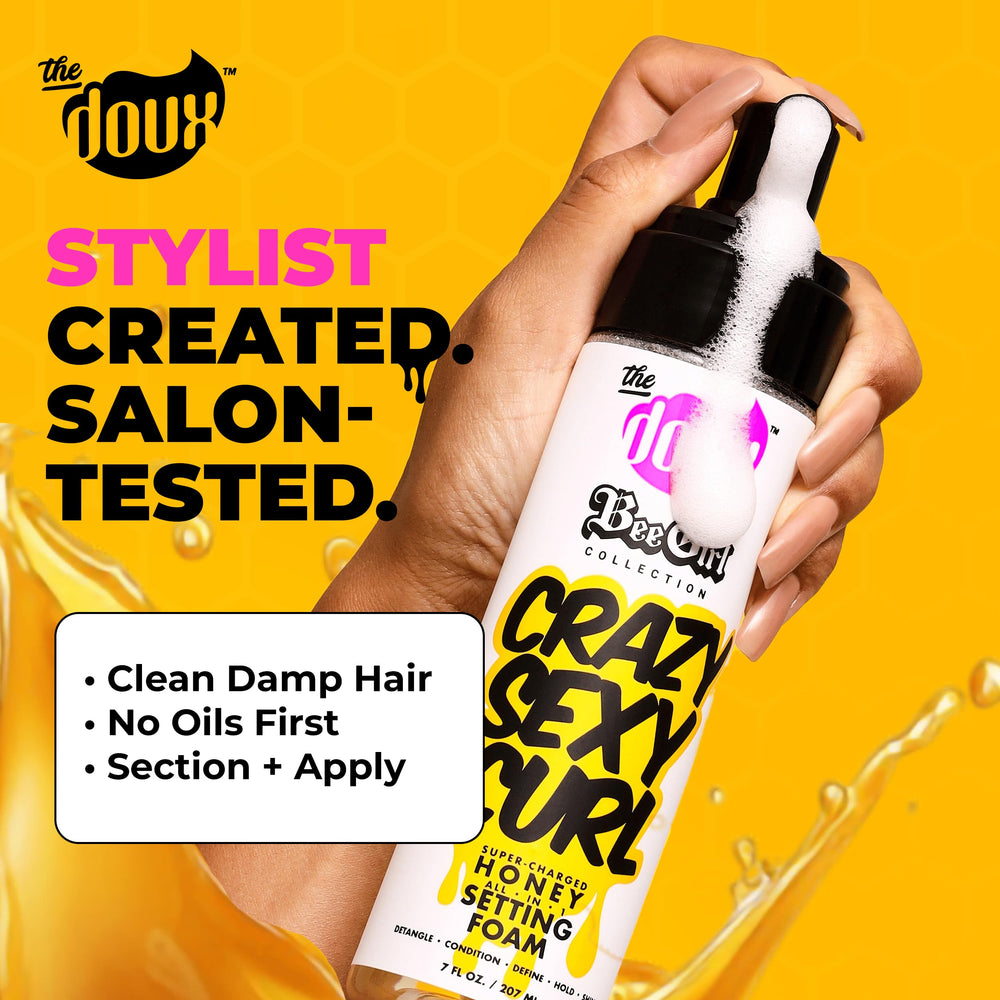 The Doux Curl Cream Setting Mousse in hand for even distribution