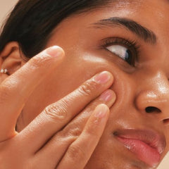 The Face Shop Rice Water Bright Light Cleansing Oil nozzle dispensing a silky makeup-melting texture.