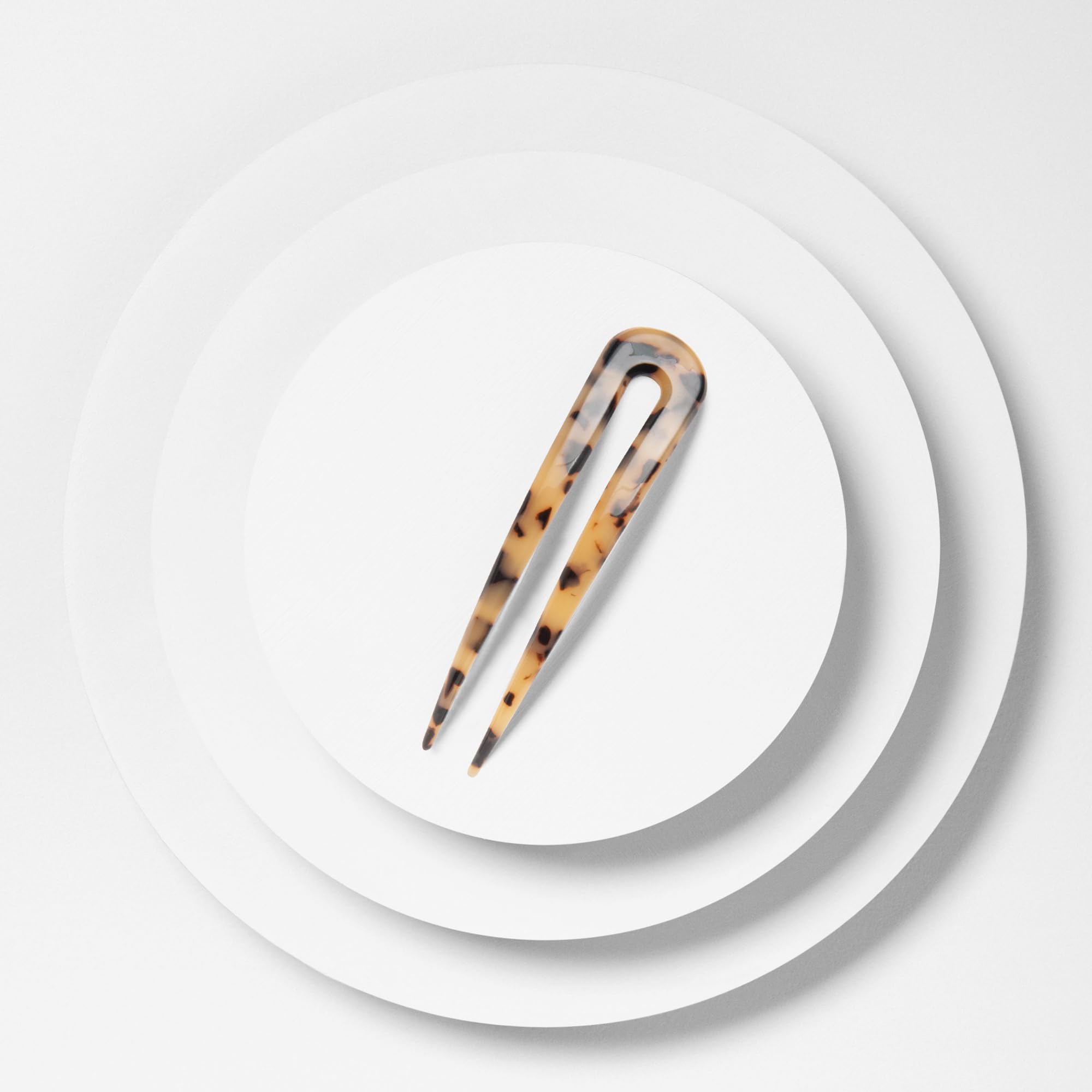 The Hair Edit Travel-friendly pin fits purse for quick styling on the go.