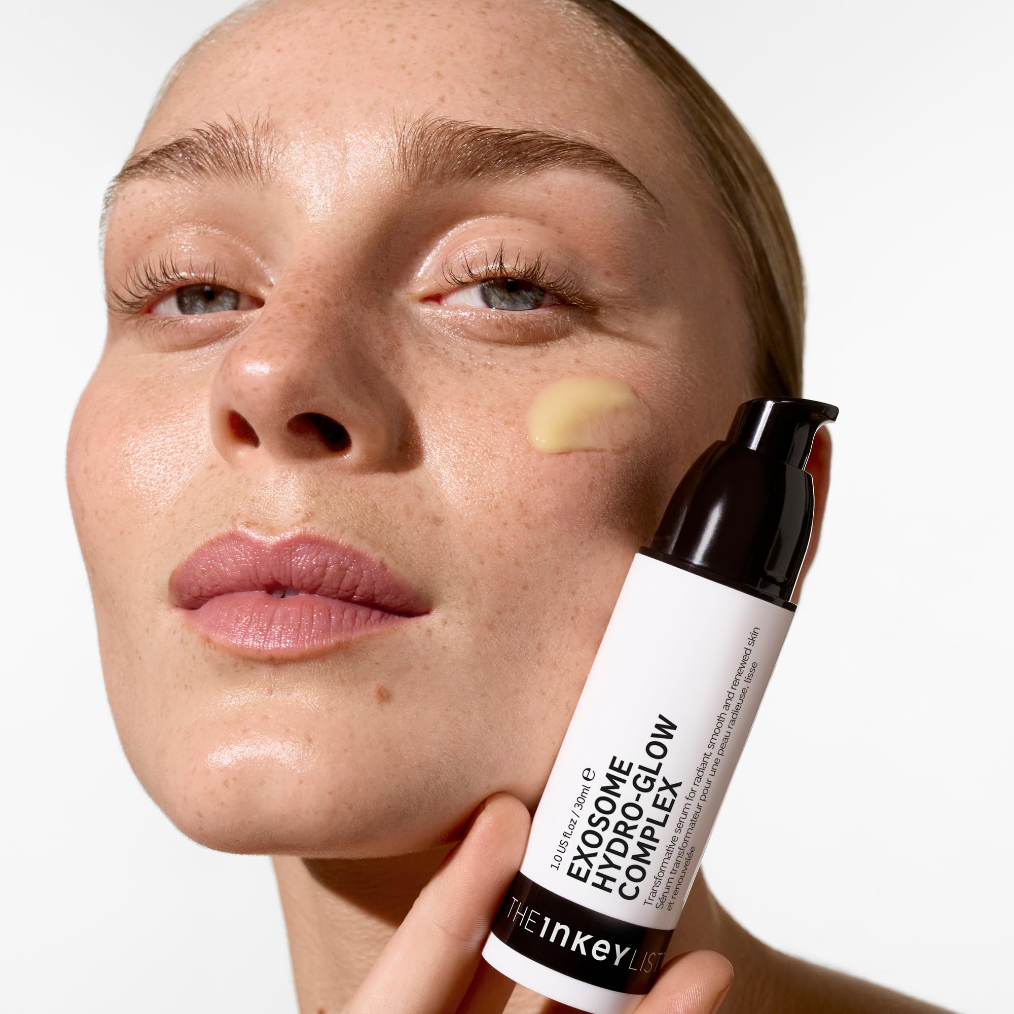 Application of The INKEY List Exosome Hydro-Glow Complex onto skin for glow.