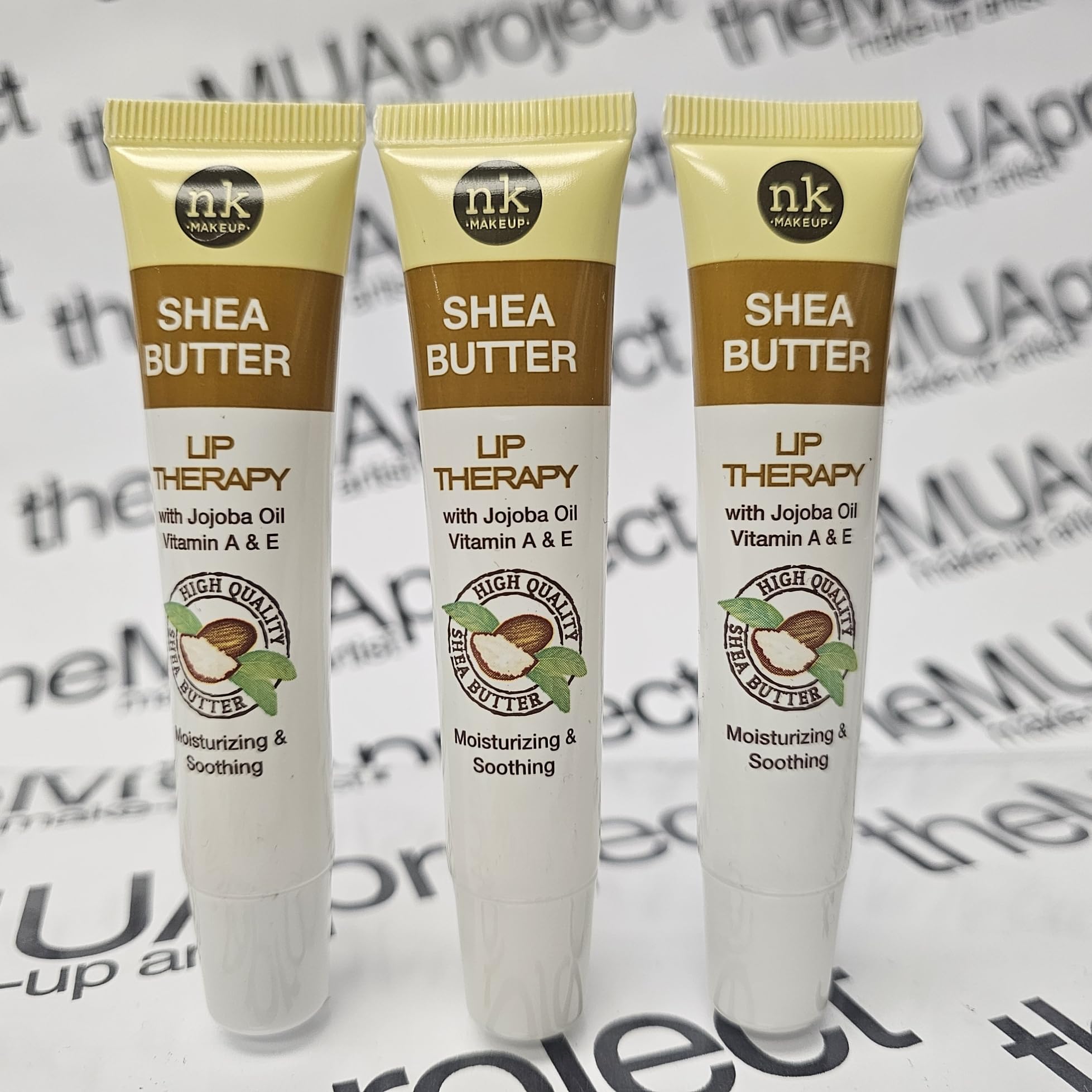 The Make-Up Artist Project Shea Butter Lip Therapy jar closeup highlights jojoba oil benefits and smooth results.