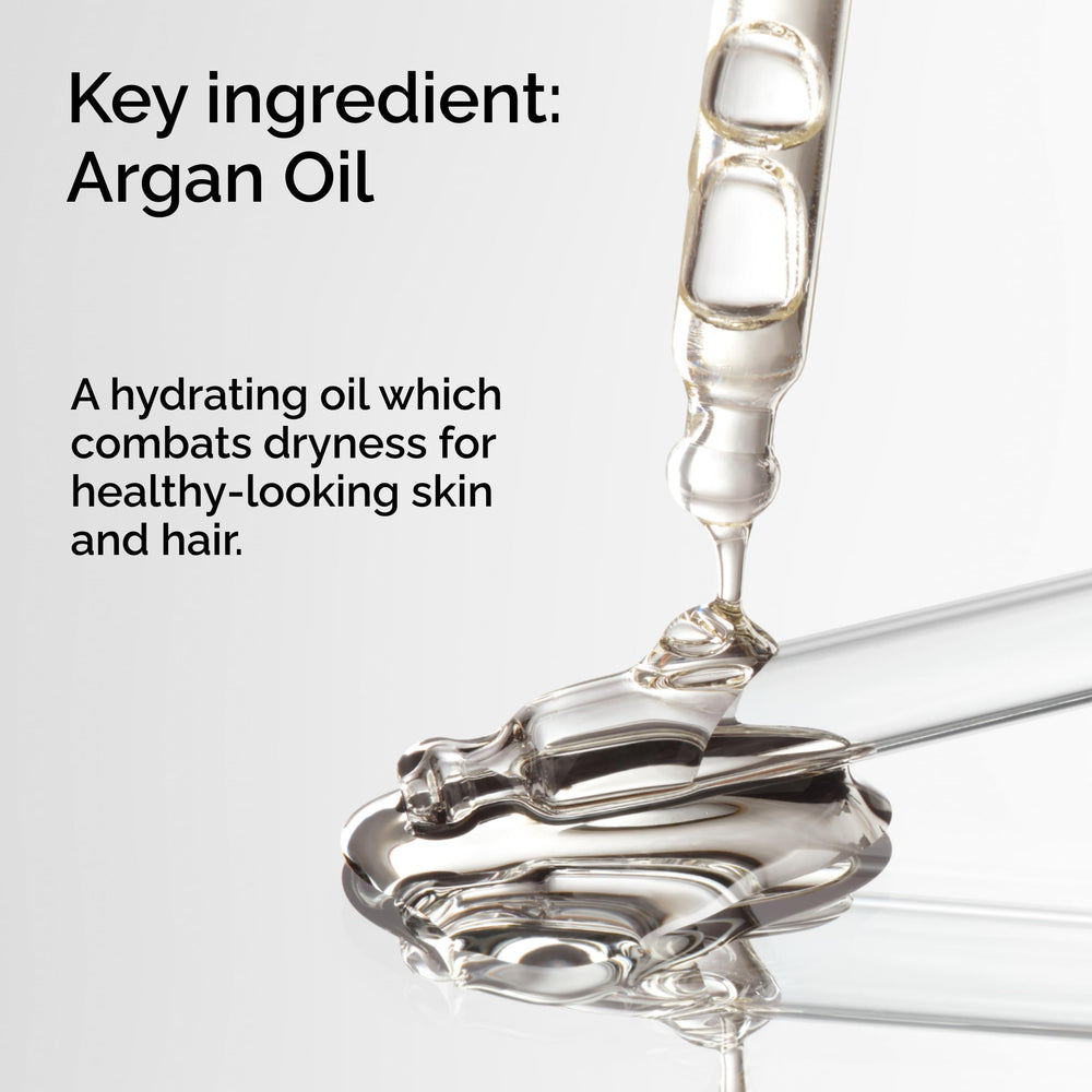 The Ordinary argan oil drops on the hand for skin nourishment.