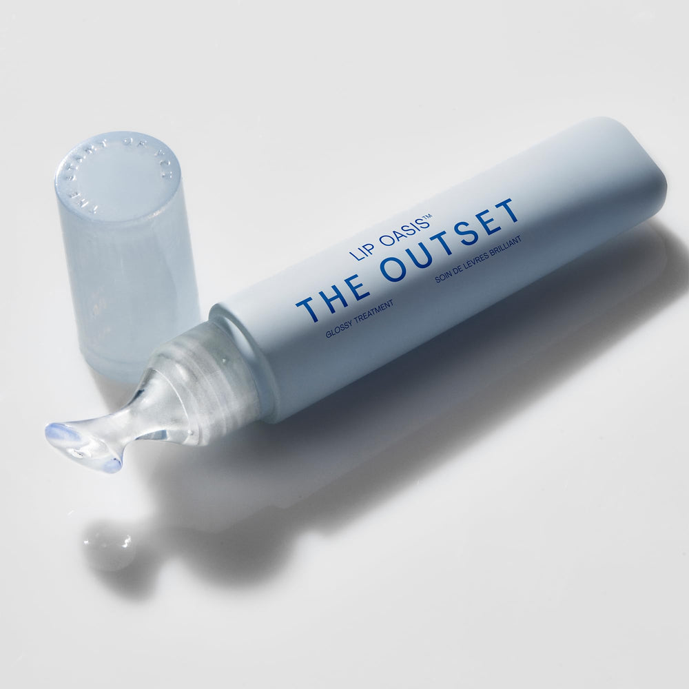 The Outset Lip Oasis Glossy Treatment tube closeup shows smooth applicator and shine