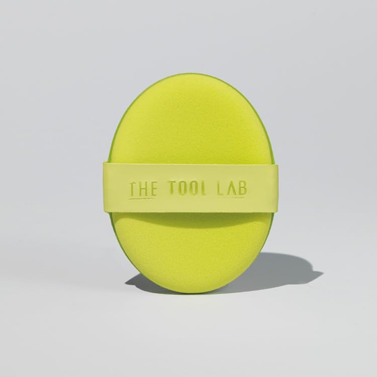 THE TOOL LAB Happyrim Aqua Puff beside foundation bottle for on-the-go blending.