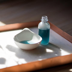 The Yellow Bird Balancing Blue Tansy Face Oil texture glistens, hinting at nourishment and glow.