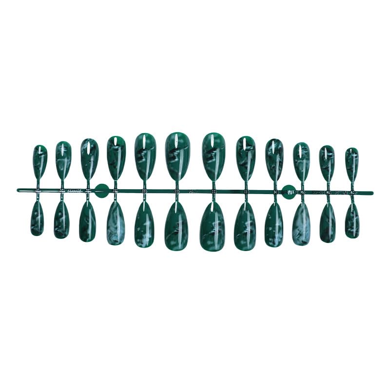 Thuoxde hand wearing green-marble press-ons showcases chic, versatile style.