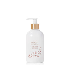 Thymes Hand Lotion Gold Pump bottle close-up, goldleaf detail signaling premium hydration for silky hands.