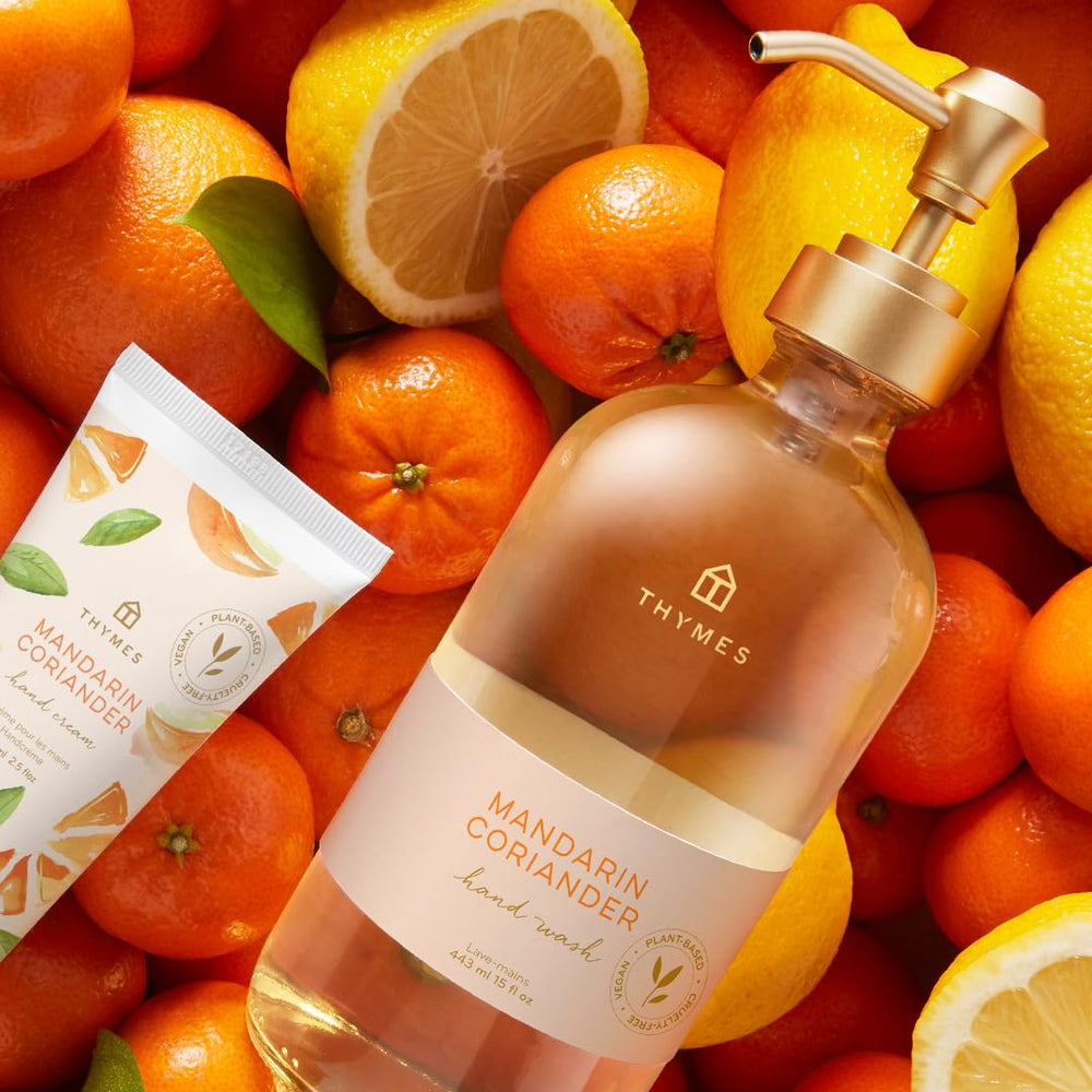 Thymes Hand Wash Mandarin Coriander ingredients closeup highlights citrus and herbs.