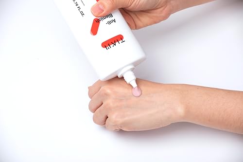Applying TIA'M Anti-Blemish Body Lotion to the back.