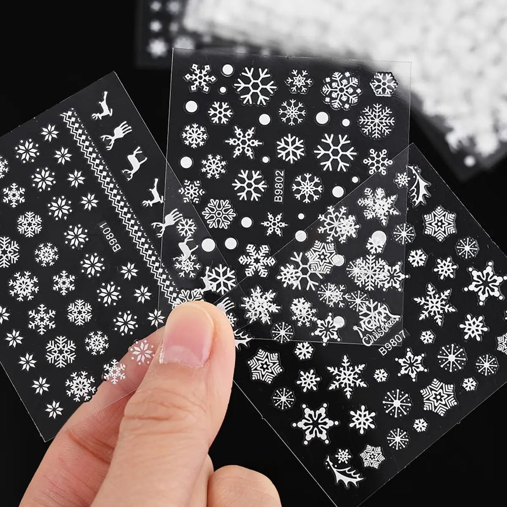Tiwnefua nails with snowflake decals highlight elegant winter style on natural nails.