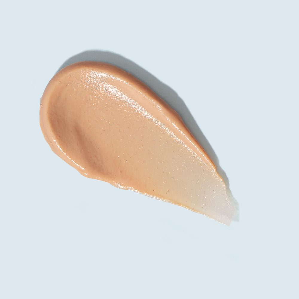 TIZO AM Replenish SPF 40 on hand shows sheer tint and moisturizing texture.