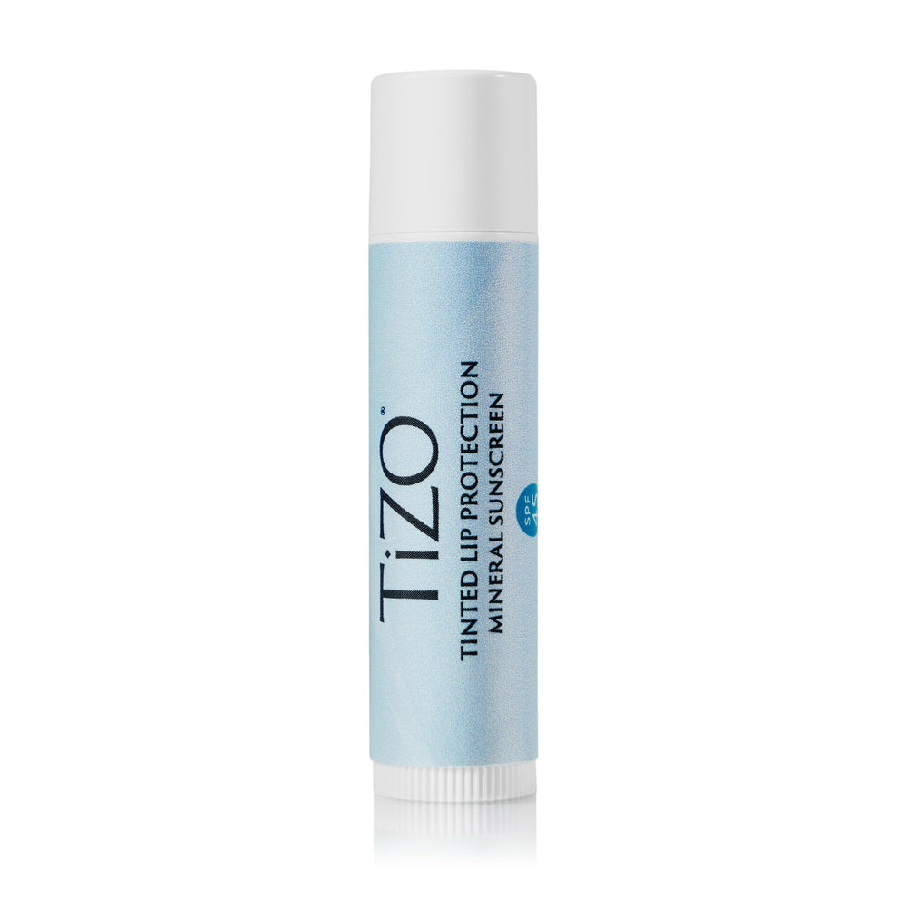 TiZO Lip Protection tinted bottle showing mineral sunscreen on lips.