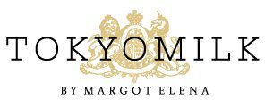 TOKYOMILK Let Them Eat Cake glass bottle close-up—luxury aesthetic on vanity