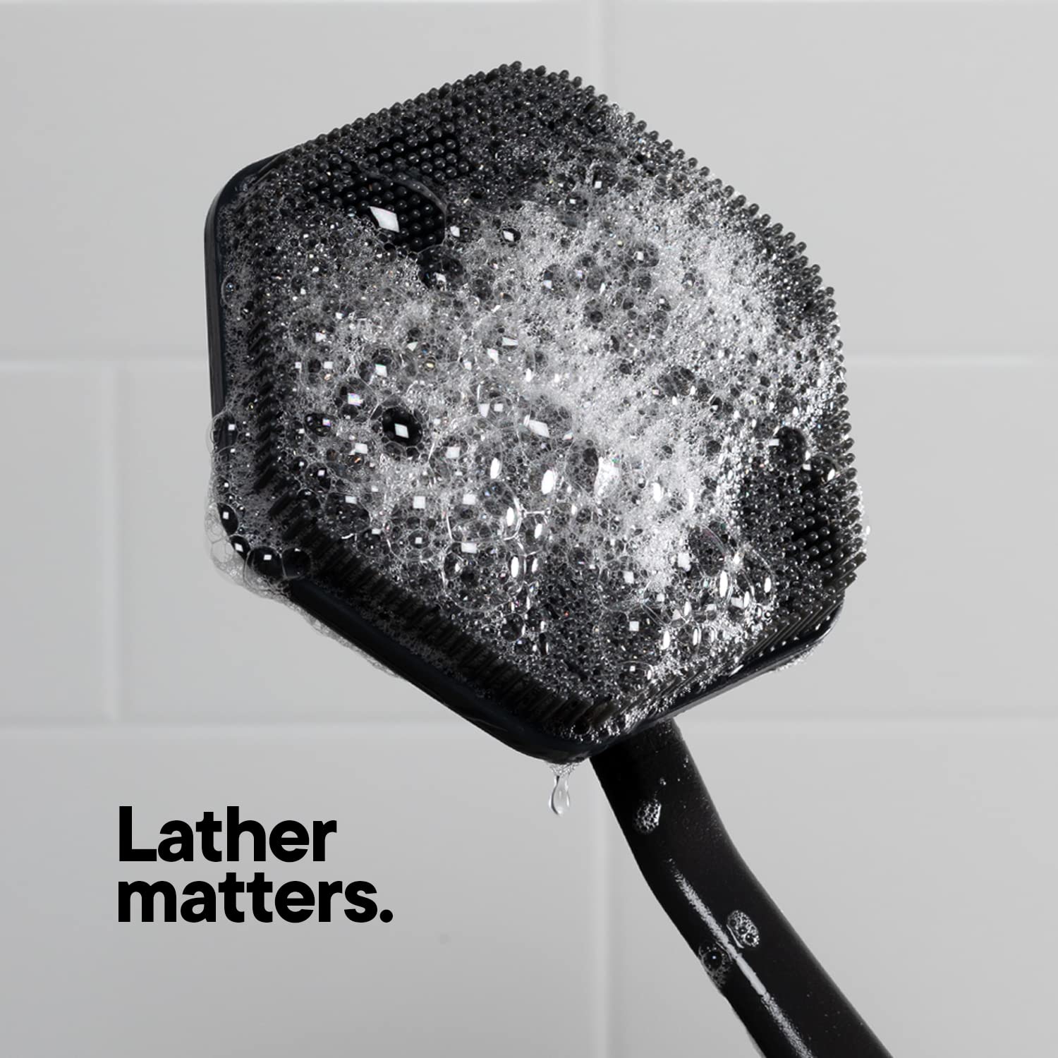 TOOLETRIES back scrubber stored neatly in a shower corner.