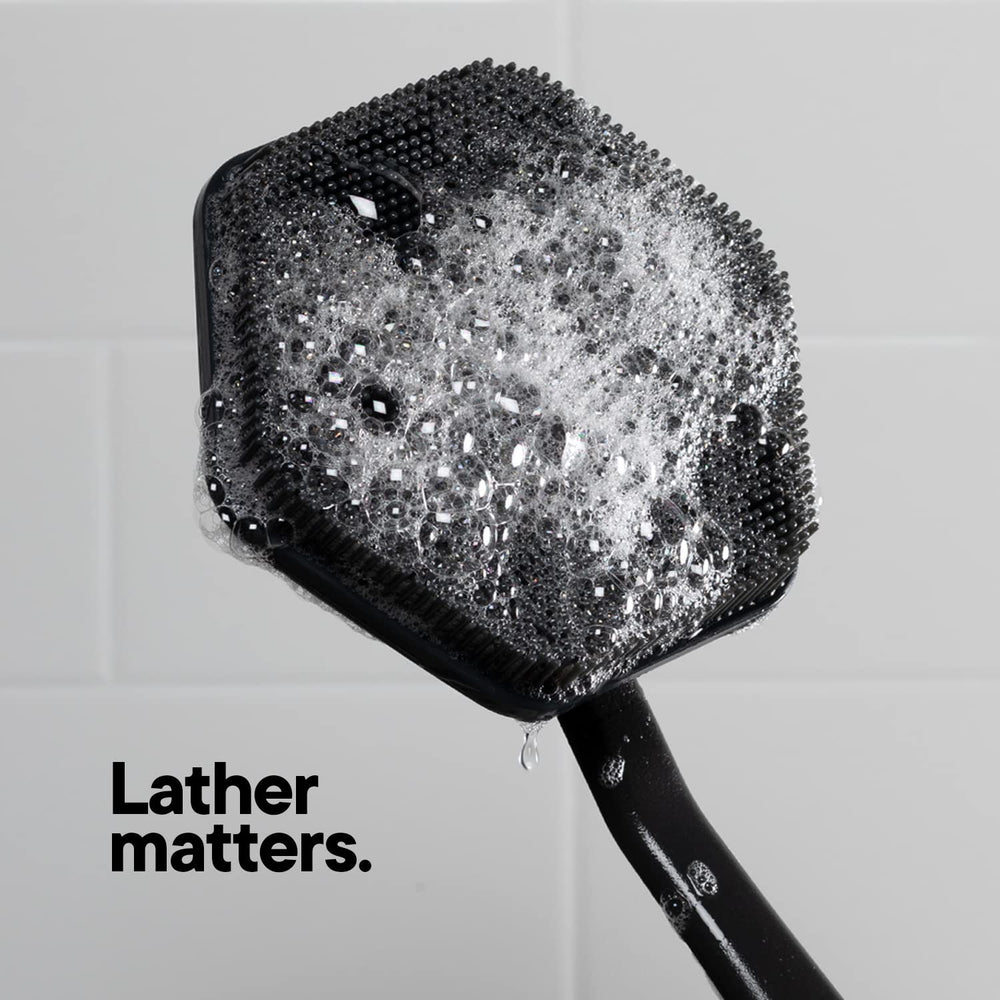 TOOLETRIES back scrubber stored neatly in a shower corner.