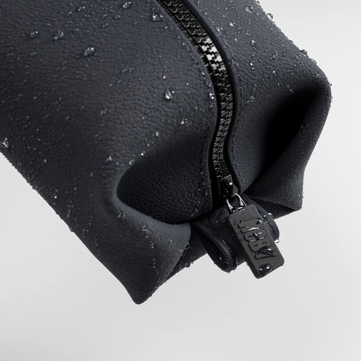 TOOLETRIES Koby Lite Dopp Kit water-resistance close-up showing spill containment