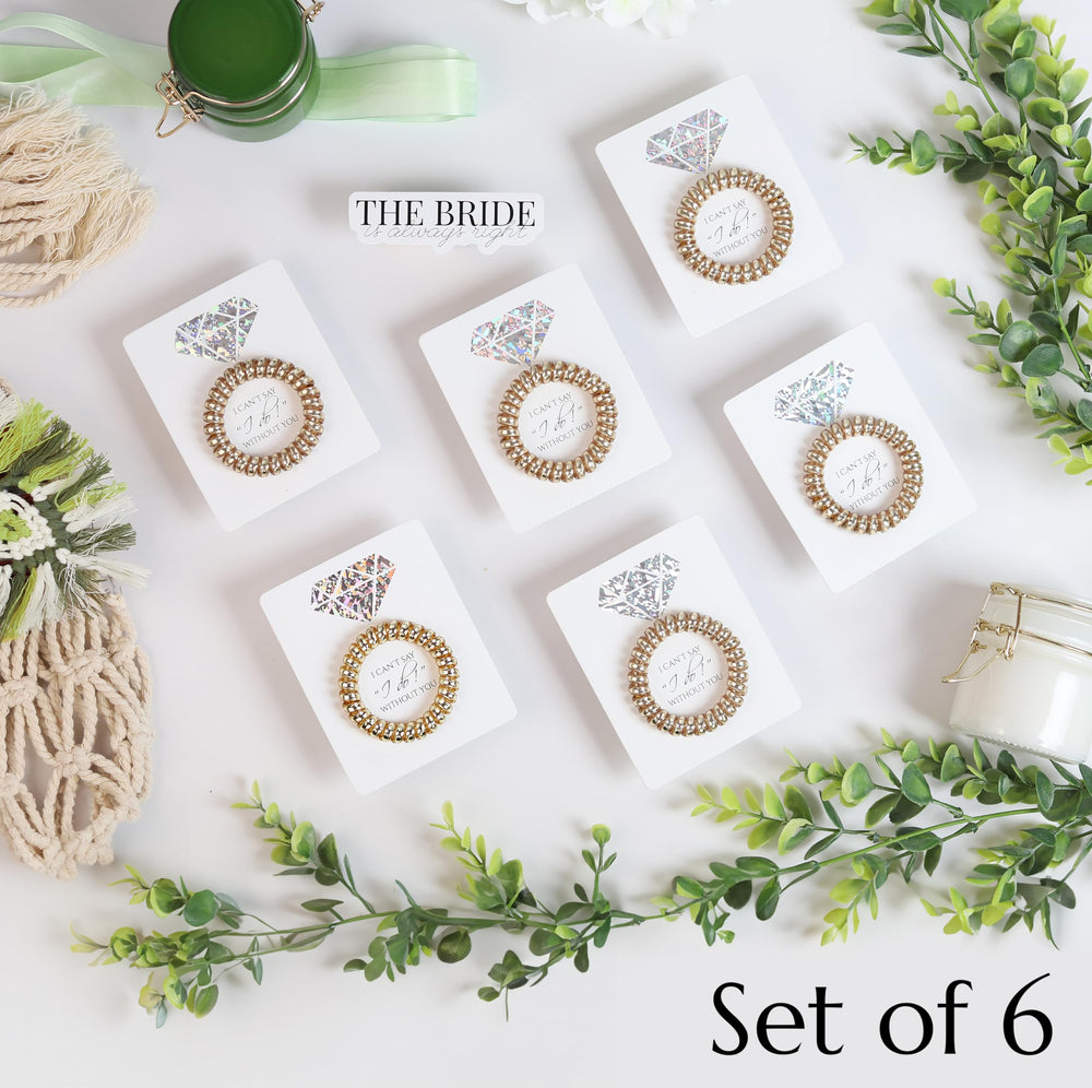 Toros proposal-card closeup shows golden spiral hair ties with elegant finish.