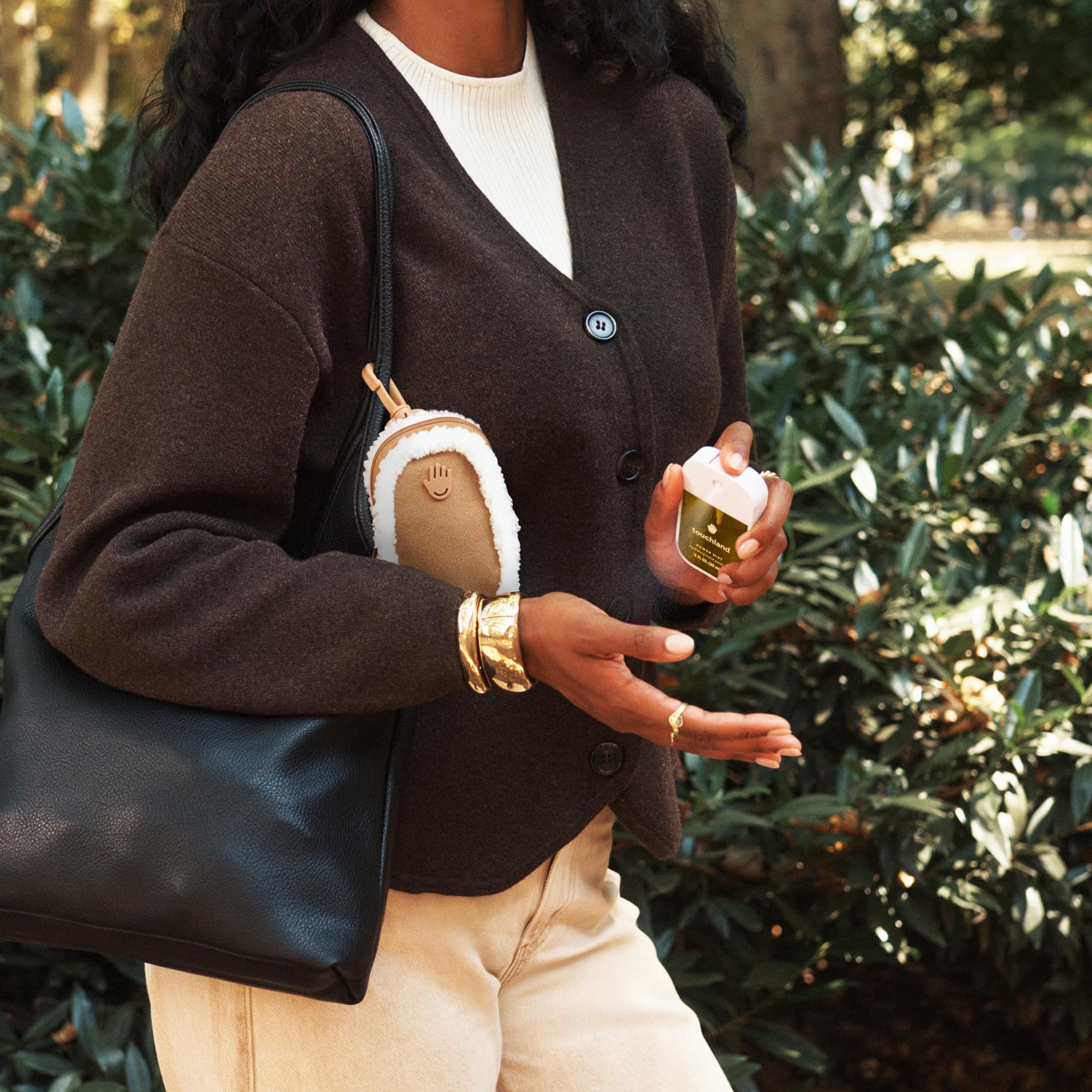 Touchland touchette with snap hook demonstrates belt-loop attachment for hands-free access