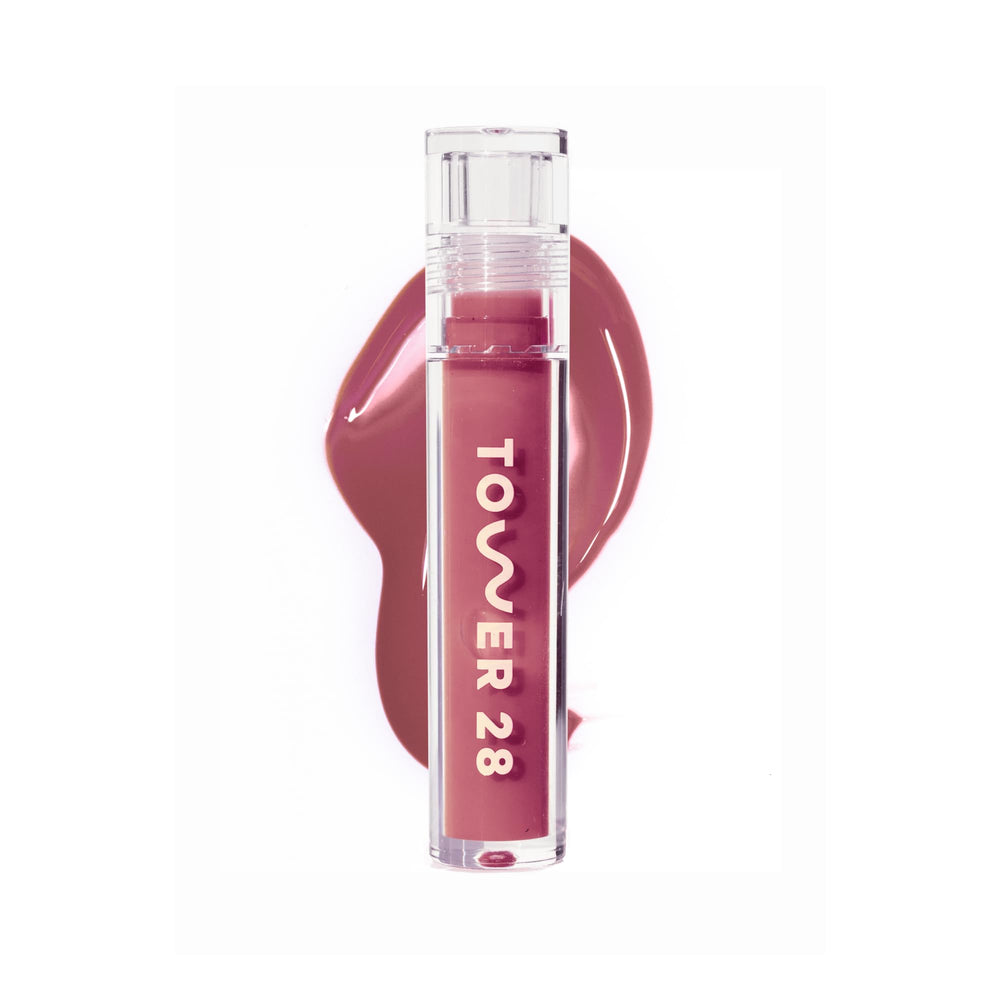 Tower 28 ShineOn Milky Lip Jelly Sesame bottle close-up highlights hydrating gloss.