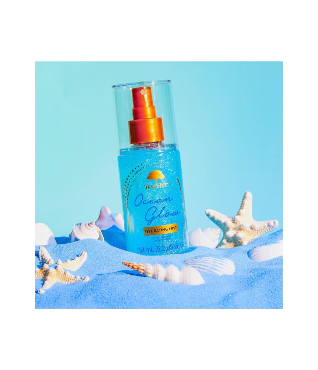Tree Hut Ocean Glow Fragrance Mist bottle emphasizes long-lasting amber-tropical scent.