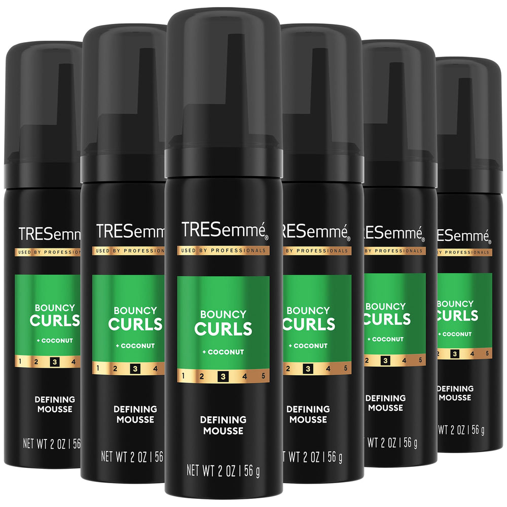 TRESemmé Defining Hair Mousse bottle front showcases defined curls.