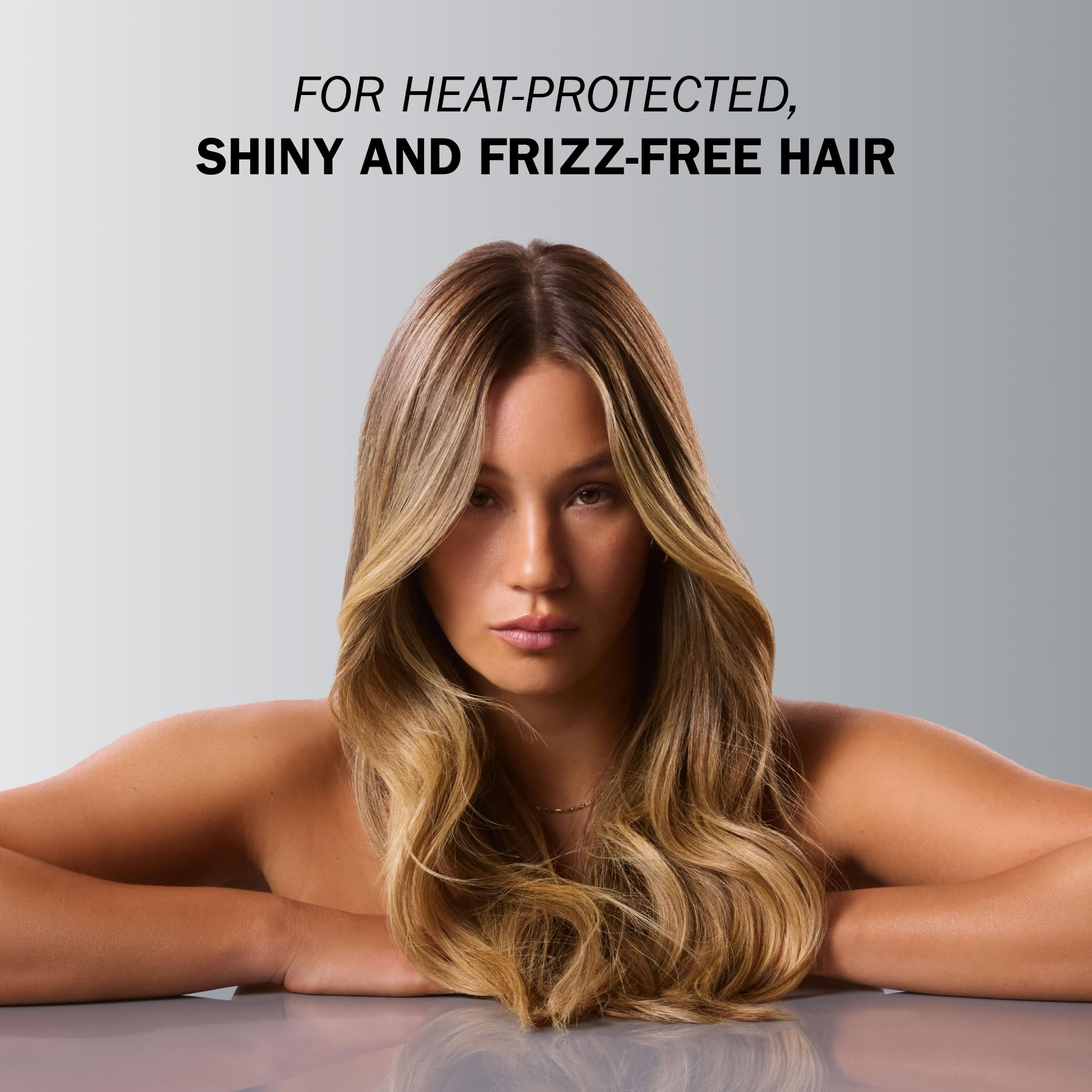 TRUSS Blond Revolution applying mist before styling for heat protection.