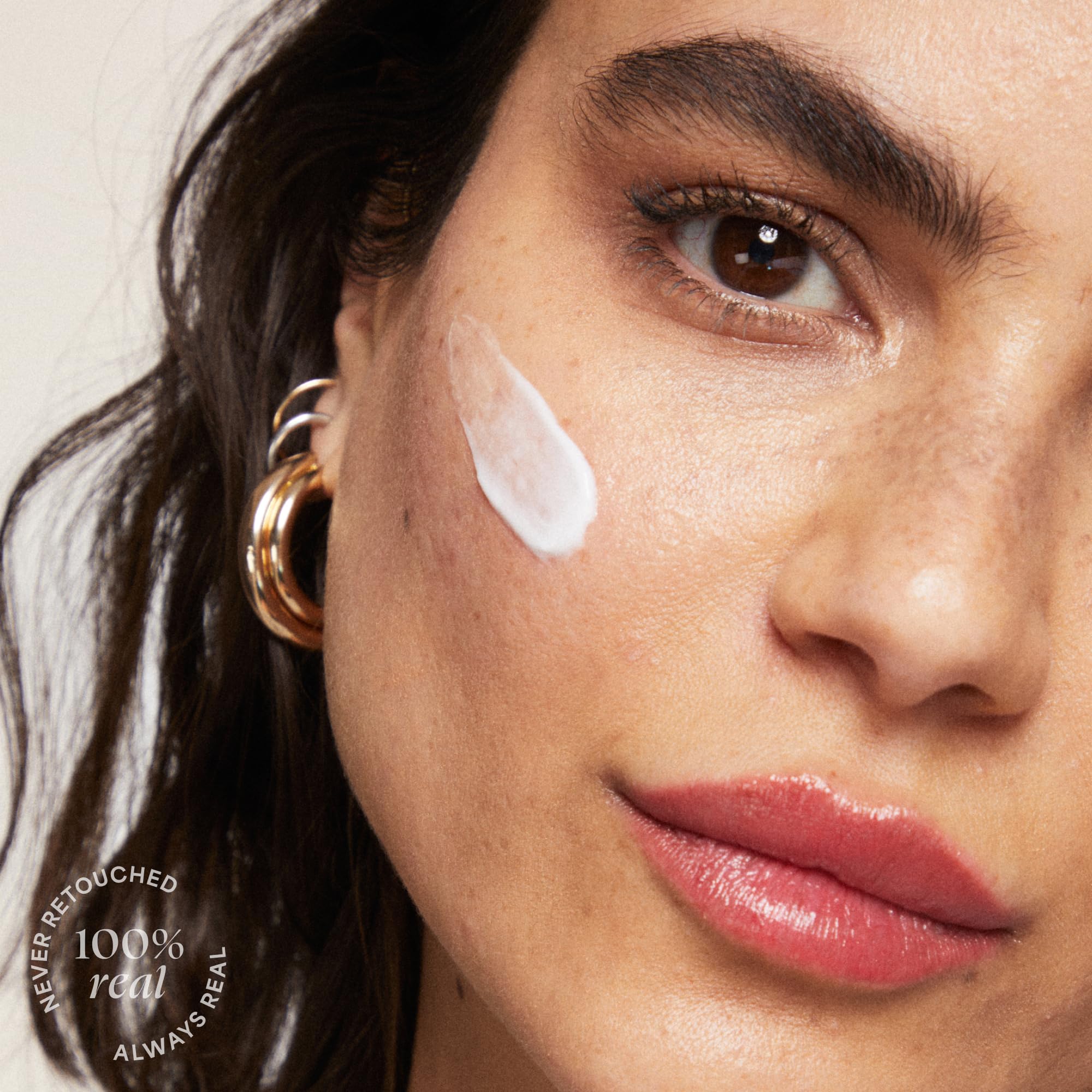 Chrome packaging beside ingredients like apple, squalane, and peptides