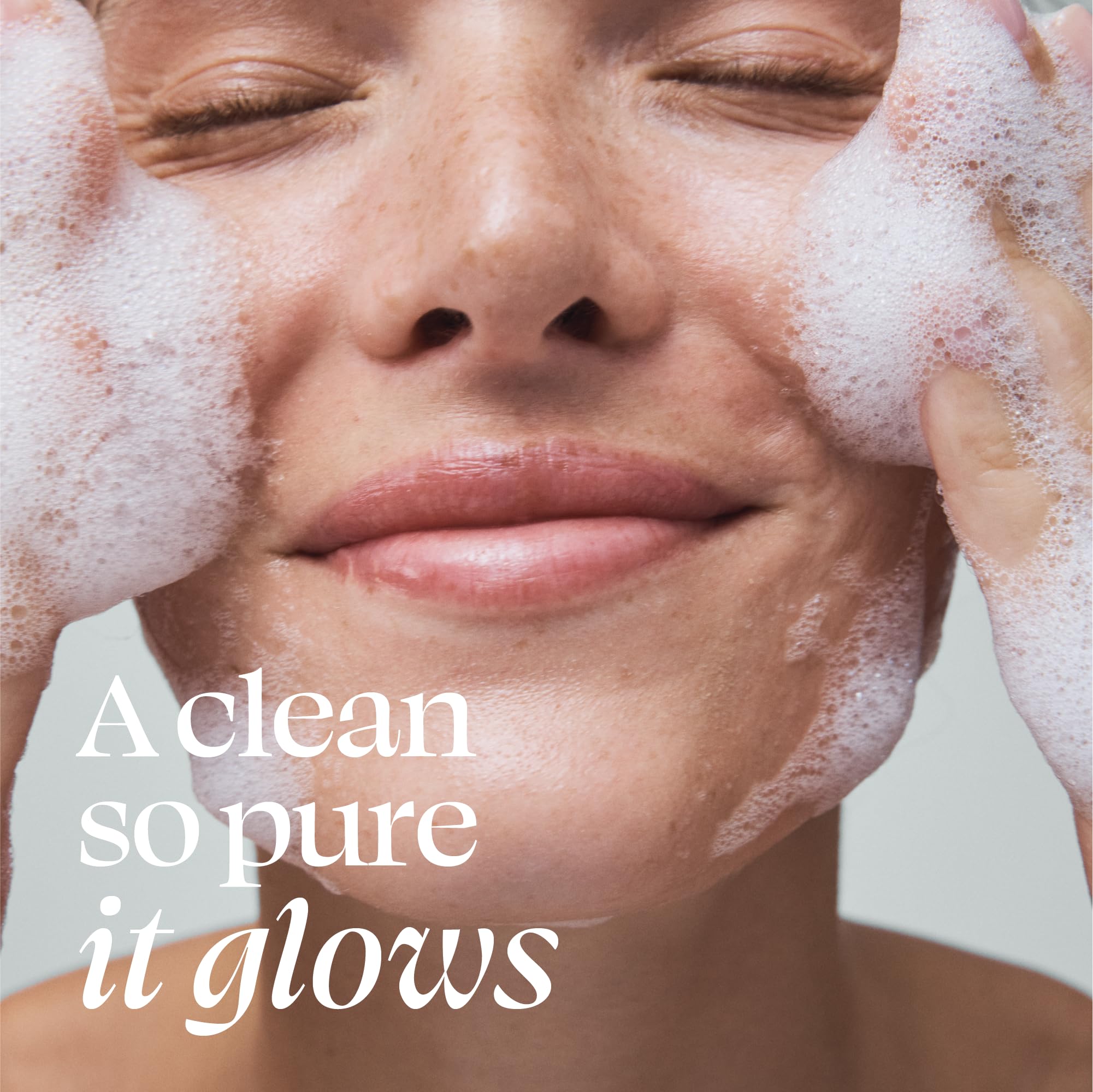 TULA Supersize Purifying Face Cleanser applied to skin by hand for makeup removal