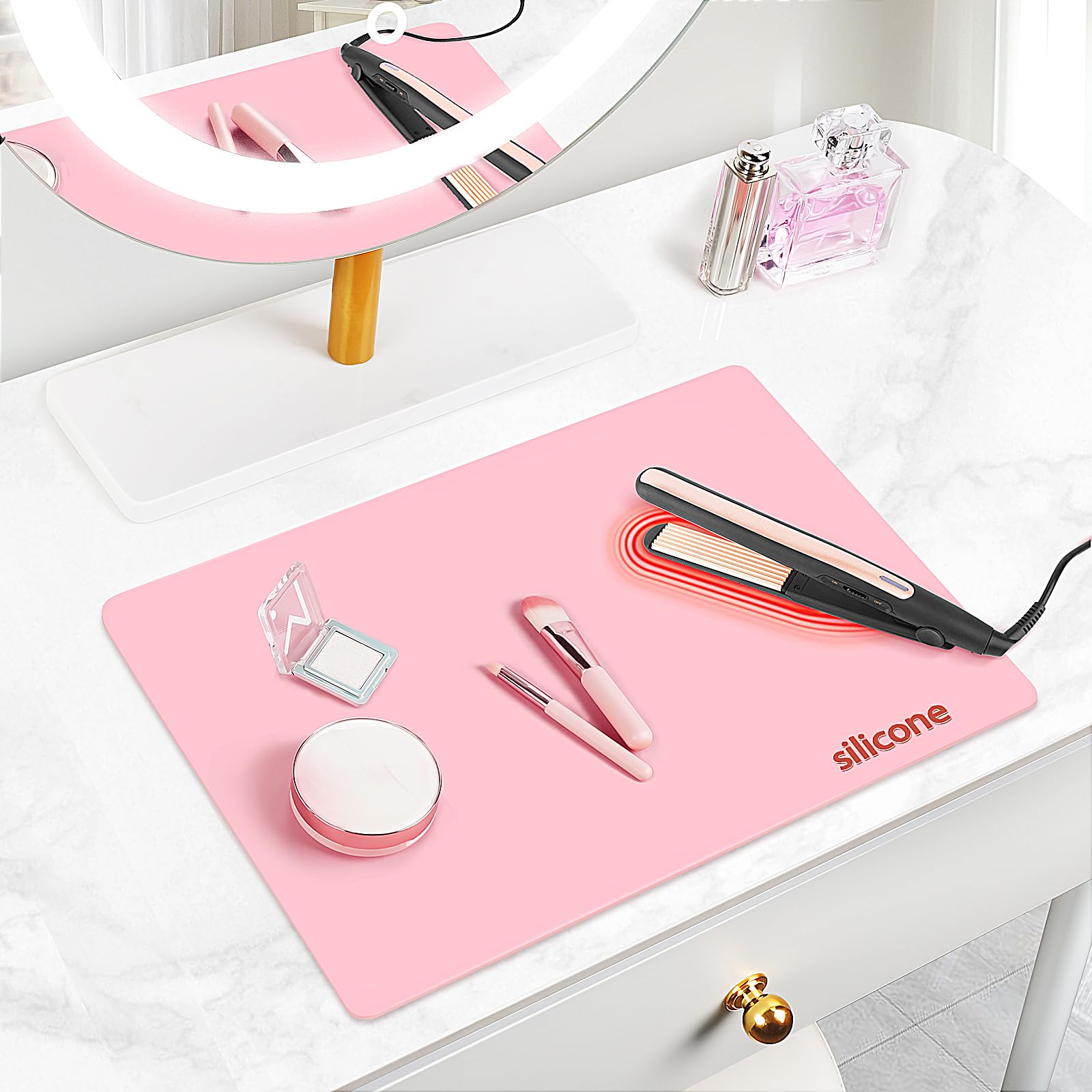 TWAKAP silicone makeup mat on vanity top pink keeps cosmetics organized.