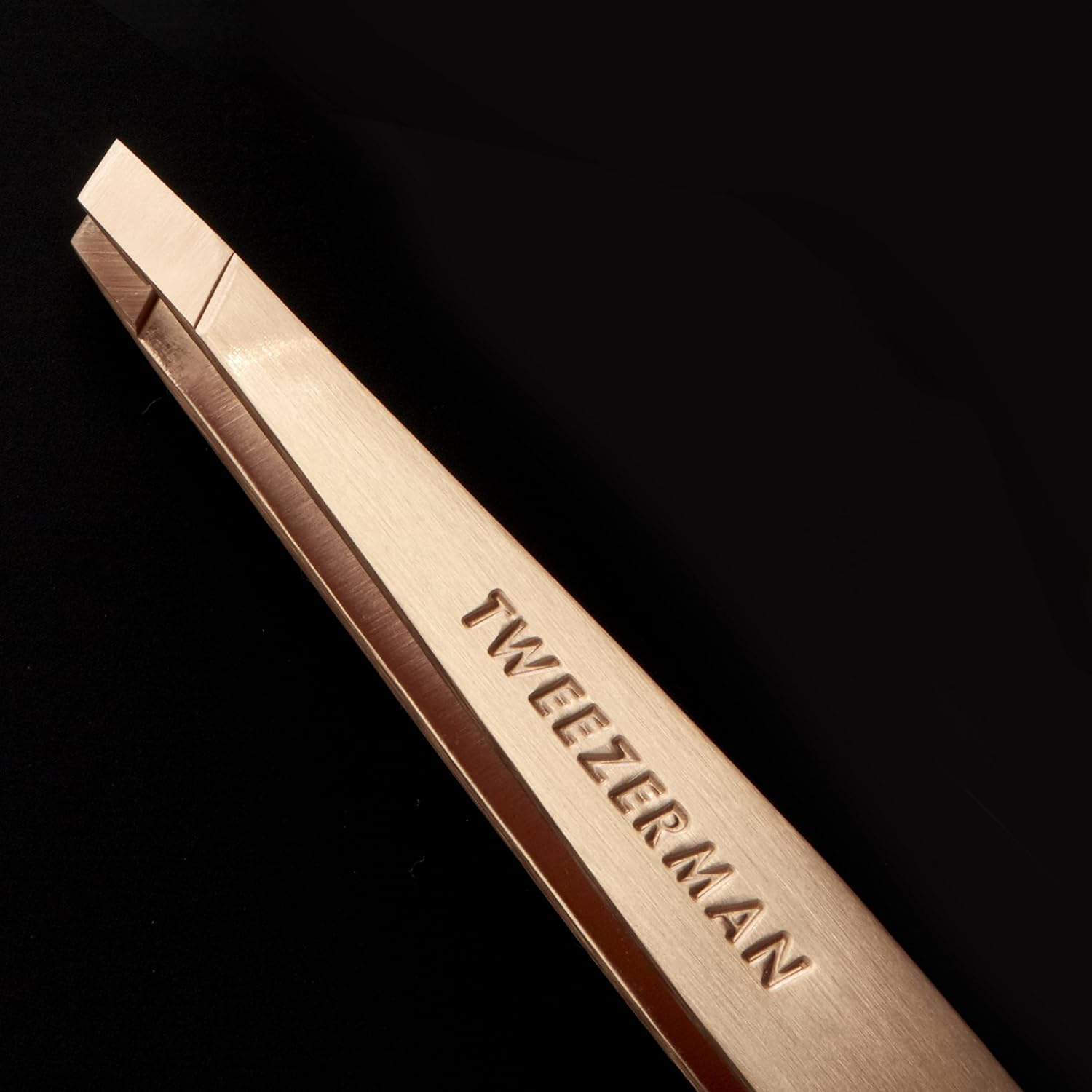 Tweezerman rose-gold slant tweezer with Allure Best of Beauty branding on packaging.