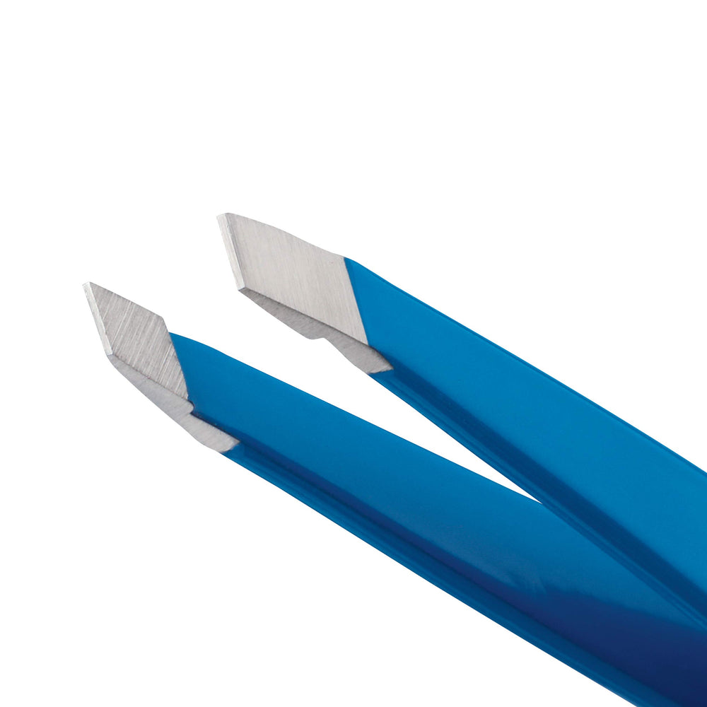 Tweezerman Mini Slant travel tweezers held in hand to demonstrate balance and control.