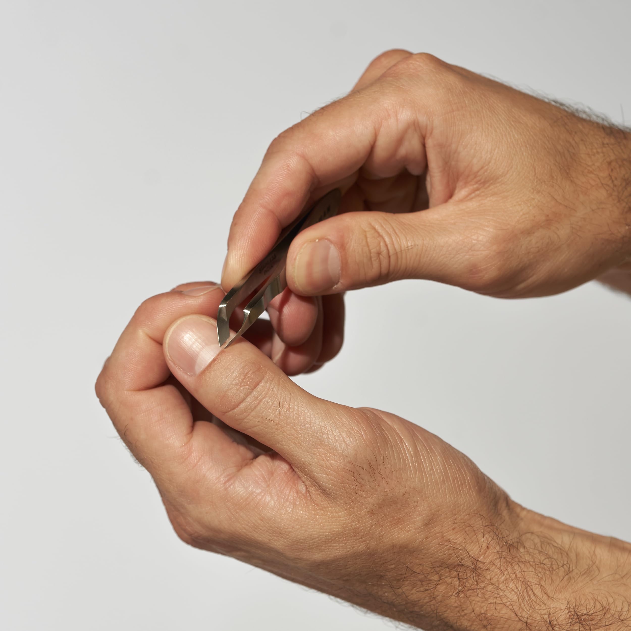 Tweezerman Mini Squeeze Cuticle Nipper textured grip for controlled trimming.