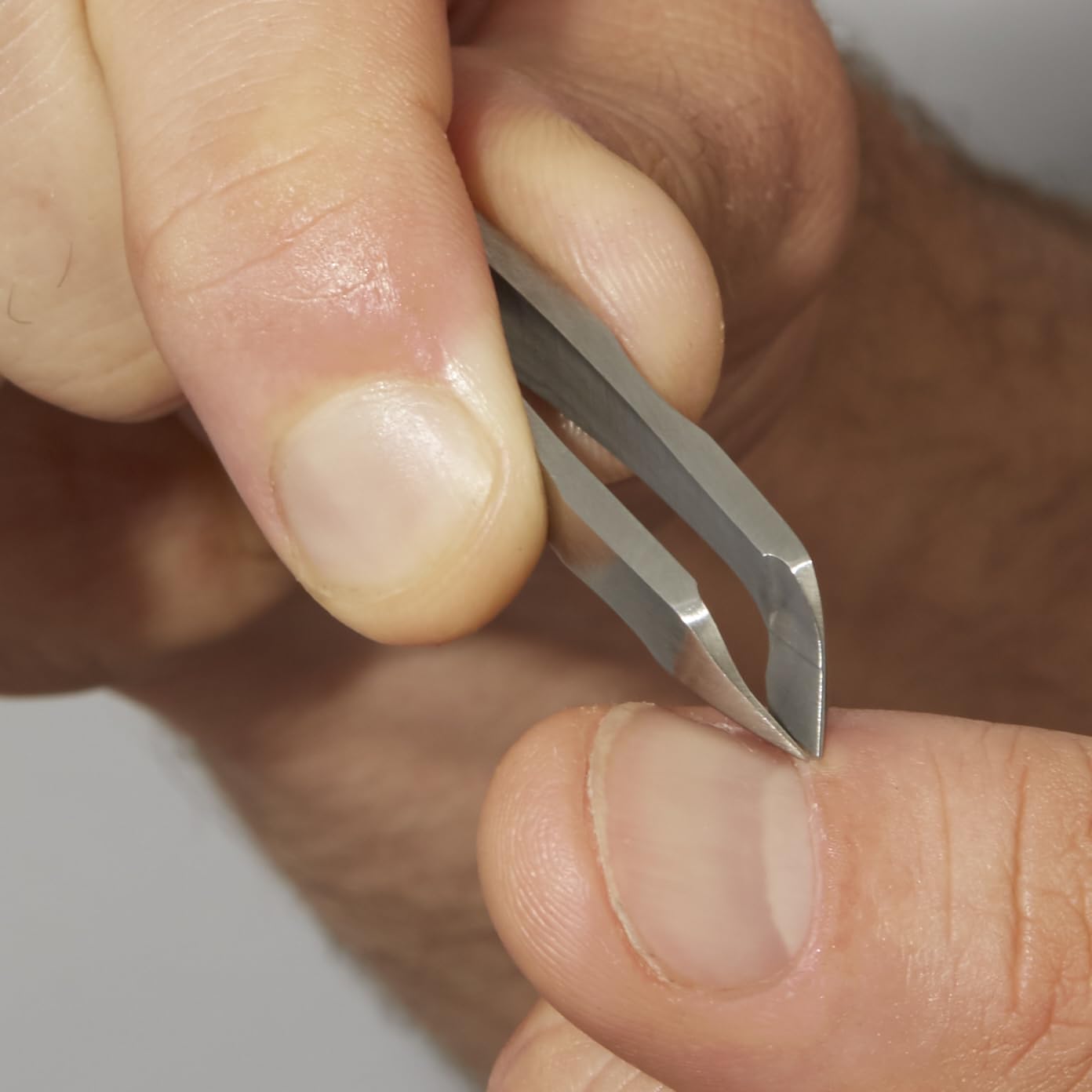 Tweezerman Mini Squeeze Cuticle Nipper compact size fits travel grooming kits.