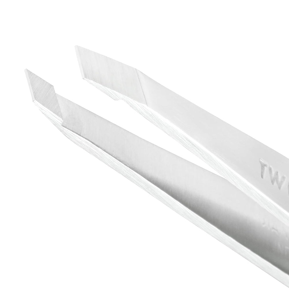 Tweezerman Platinum Silver tweezer in use with firm grip for controlled hair removal.