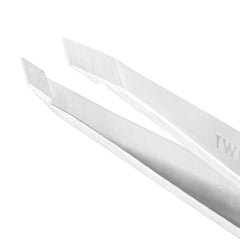 Tweezerman Platinum Silver tweezer in use with firm grip for controlled hair removal.