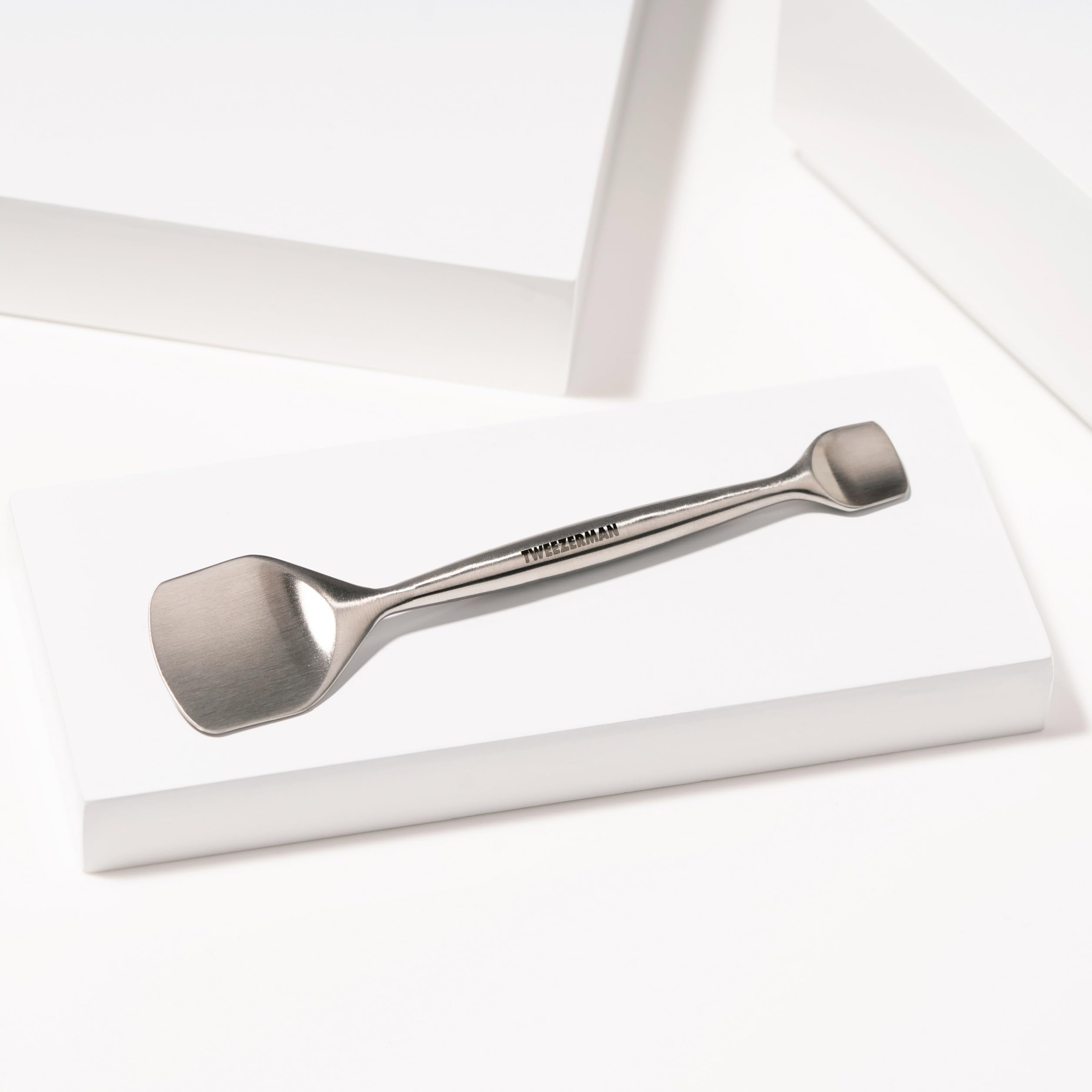 Tweezerman pore prep tool taut-skin technique shows gentle pressure lifting debris.