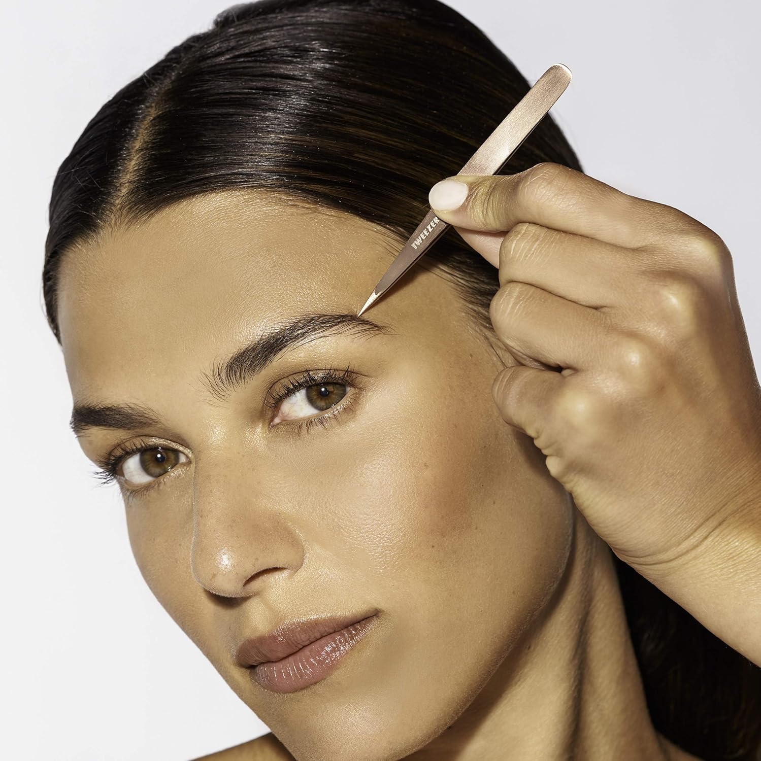 Tweezerman rose-gold tweezer grip provides comfortable control for precise hair removal.