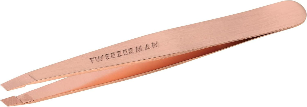 Tweezerman rose-gold slant tweezer close-up showing precision for brow shaping.