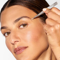 Tweezerman steel point tweezer silver in-use for eyebrow shaping and precise plucking