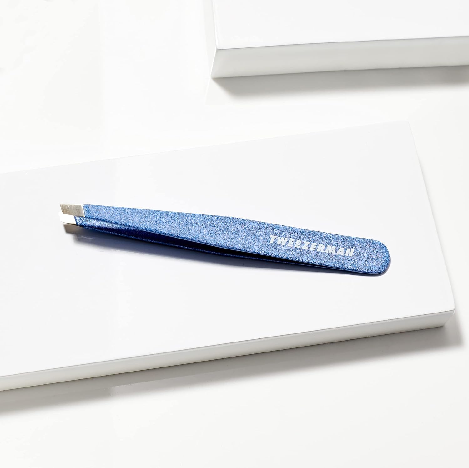 Tweezerman travel case with sky-blue tweezer for on-the-go grooming