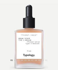 Typology tinted serum being applied with brush for easy, even coverage.