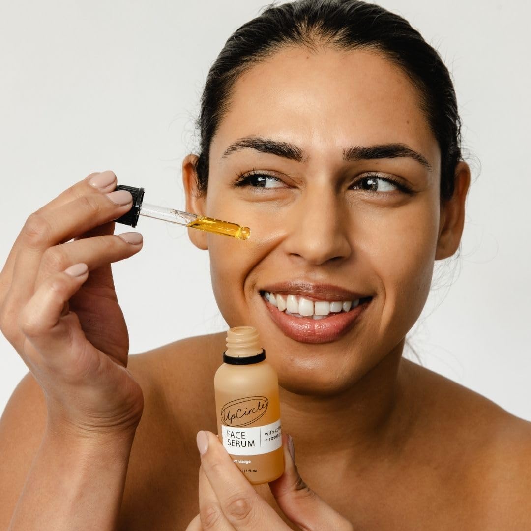 User applying UpCircle serum in morning routine for smooth skin.