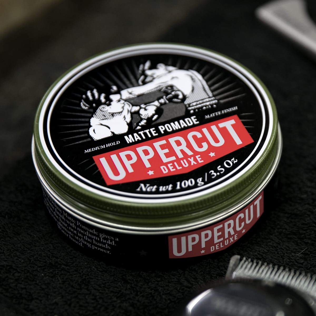 Close-up texture of Uppercut Deluxe Matte Pomade showing its creamy consistency.